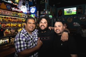 three men enjoying fat angel sports bar